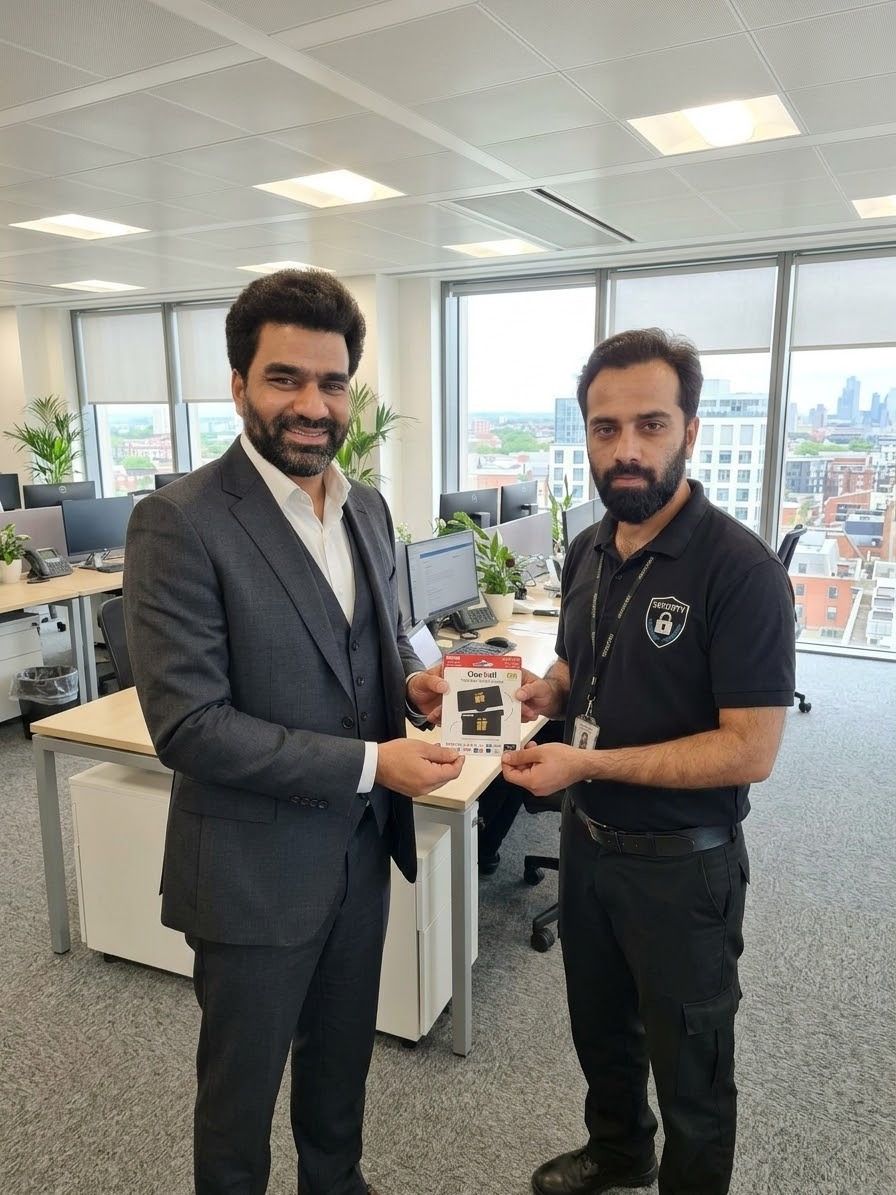 Managing Director Syed Shujaat Masood Shah presenting Employee of the Quarter Muhammad Furqan Amir with an Amazon voucher in the BMS office